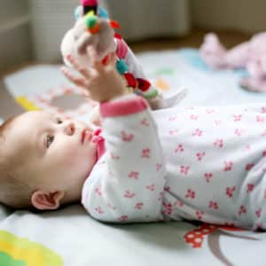 A 5 Month Old Baby Girl Observing A Toy
